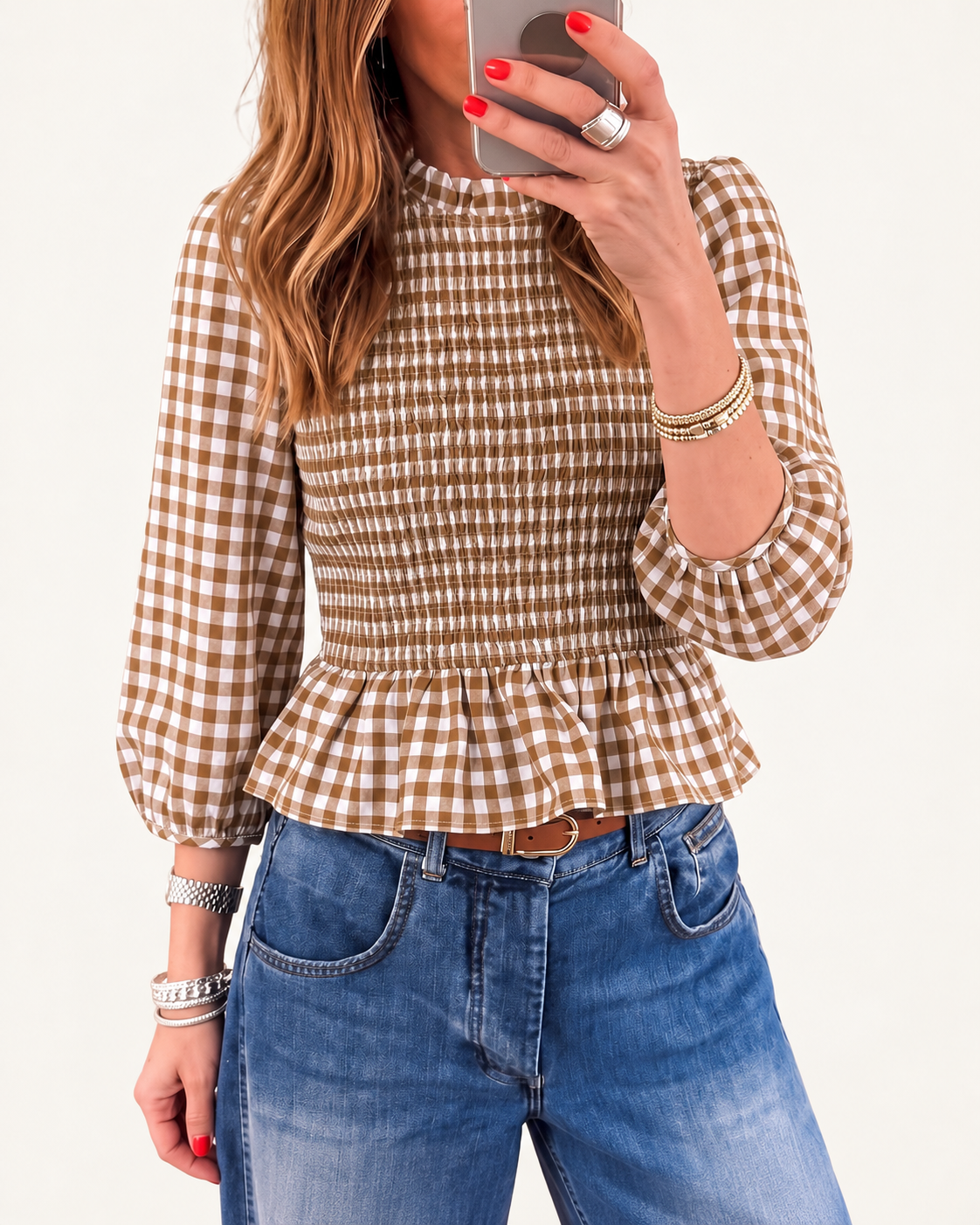 Brown plaid shirred peplum top on ivory studio background